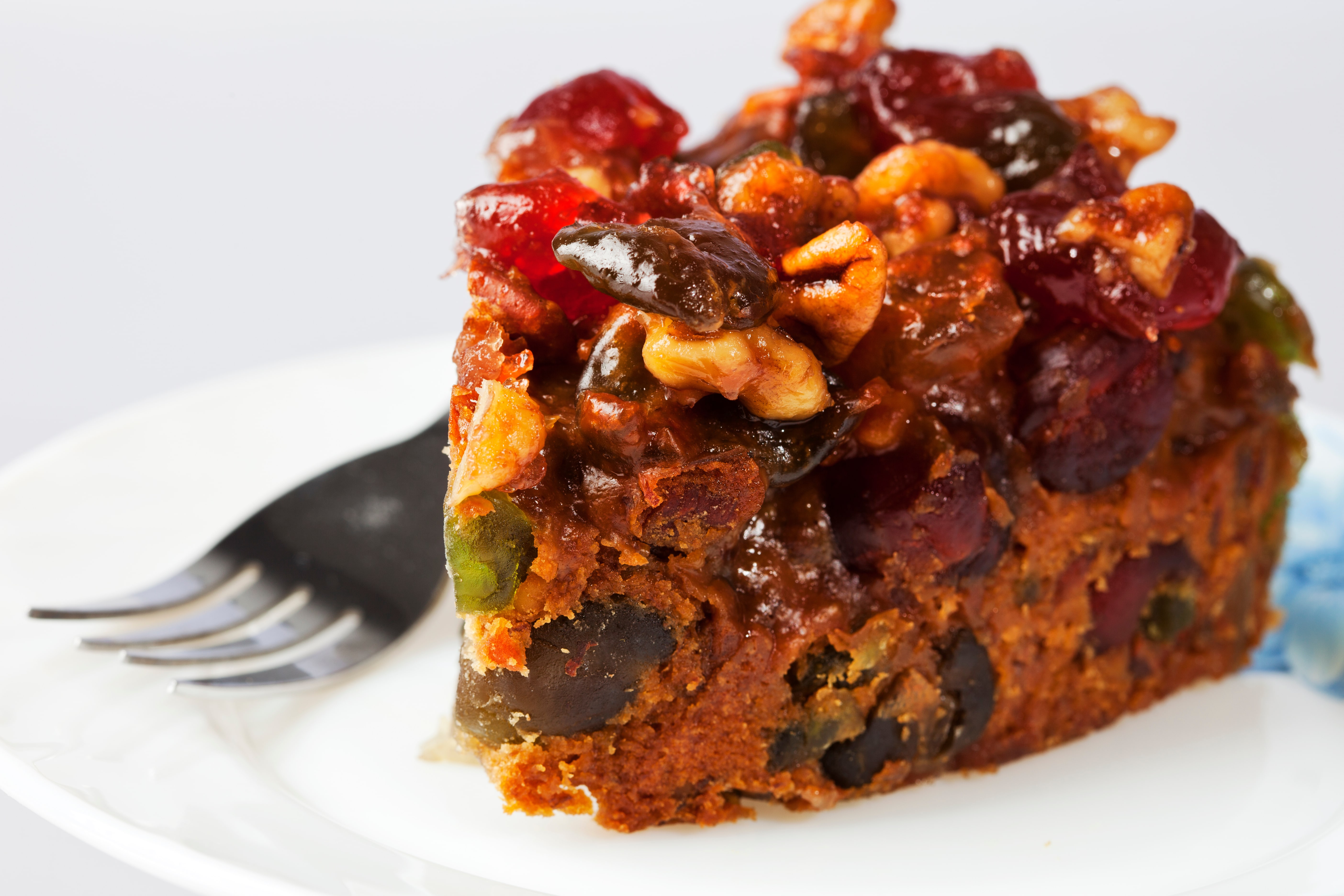 Slice of fruitcake with nuts on top