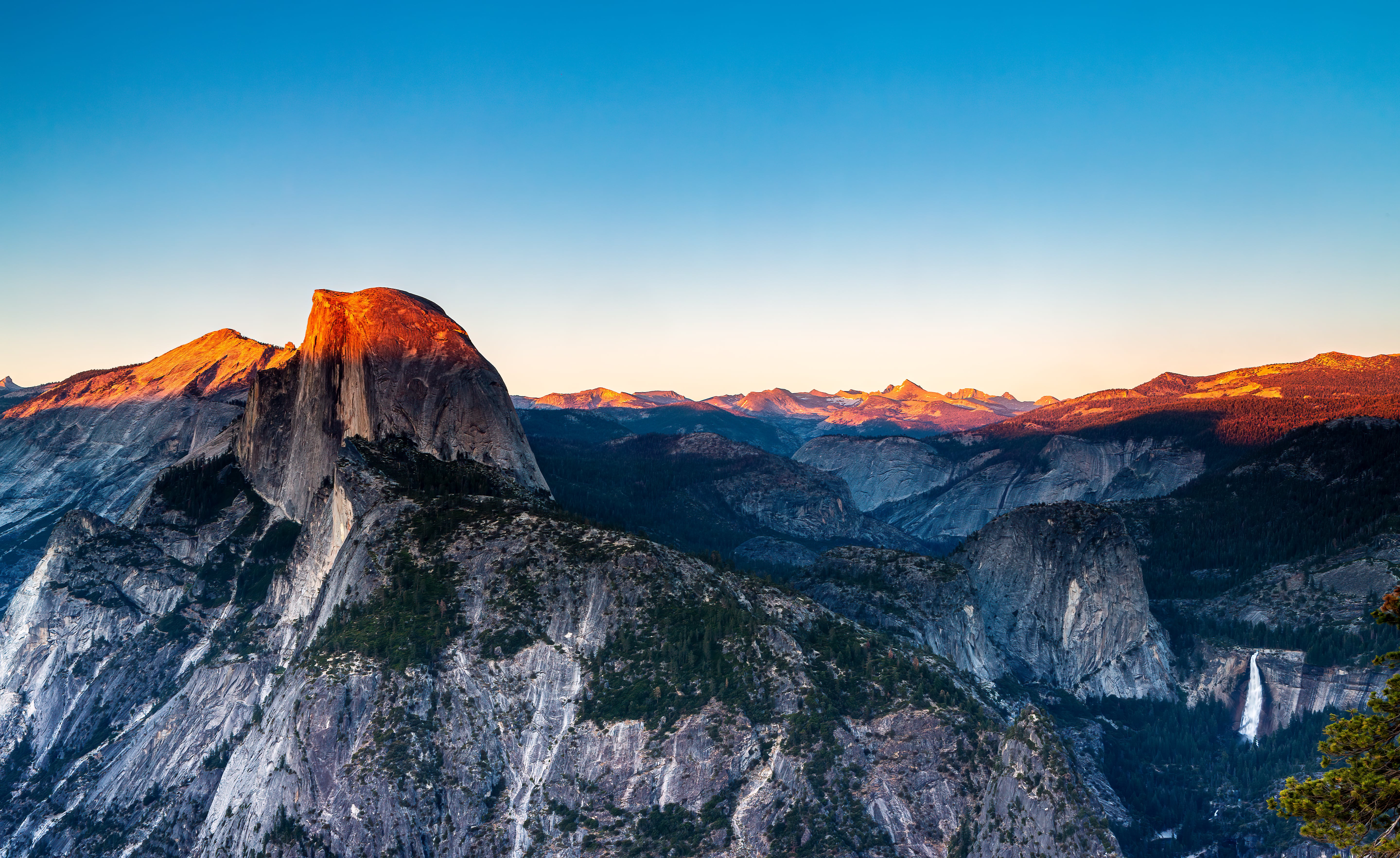 Sunset casts a golden glow on Half Dome in Yosemite National Park, California