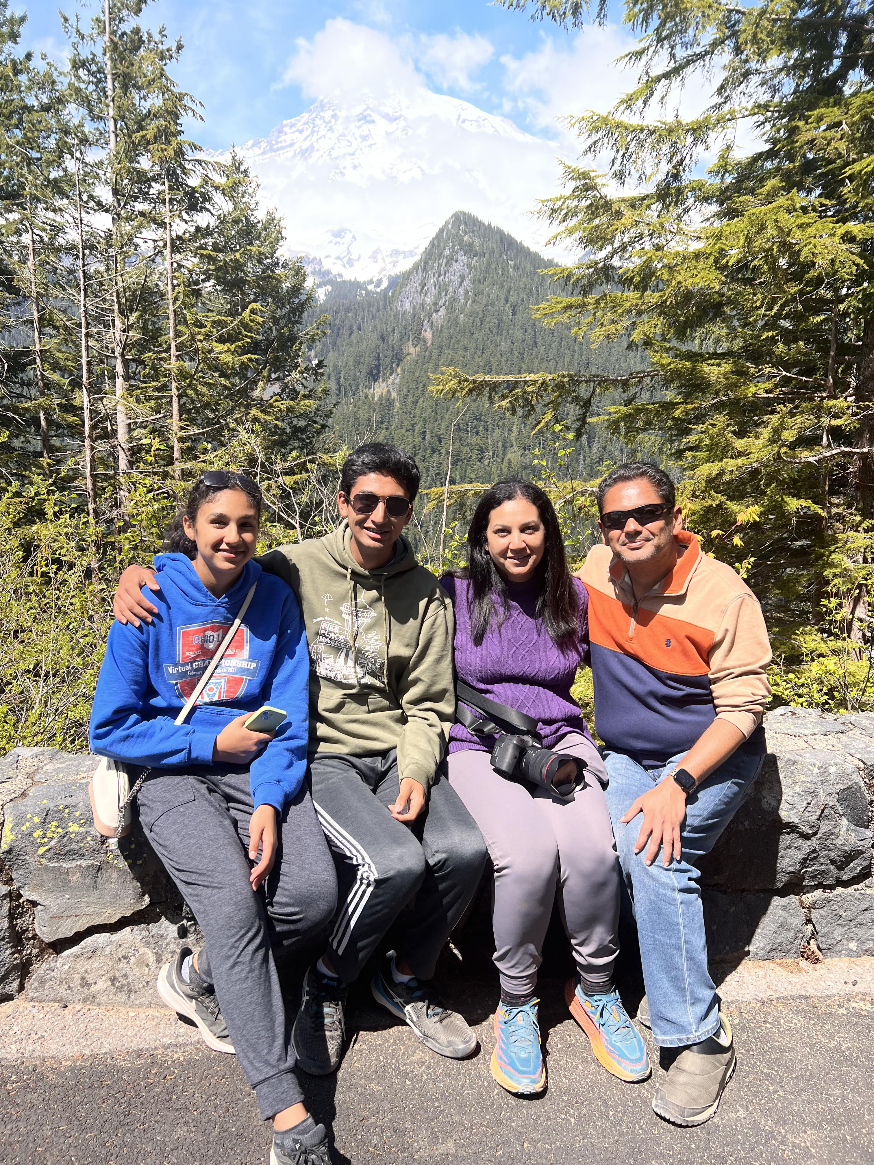 Family sitting in front of Mount Rainier in Washington