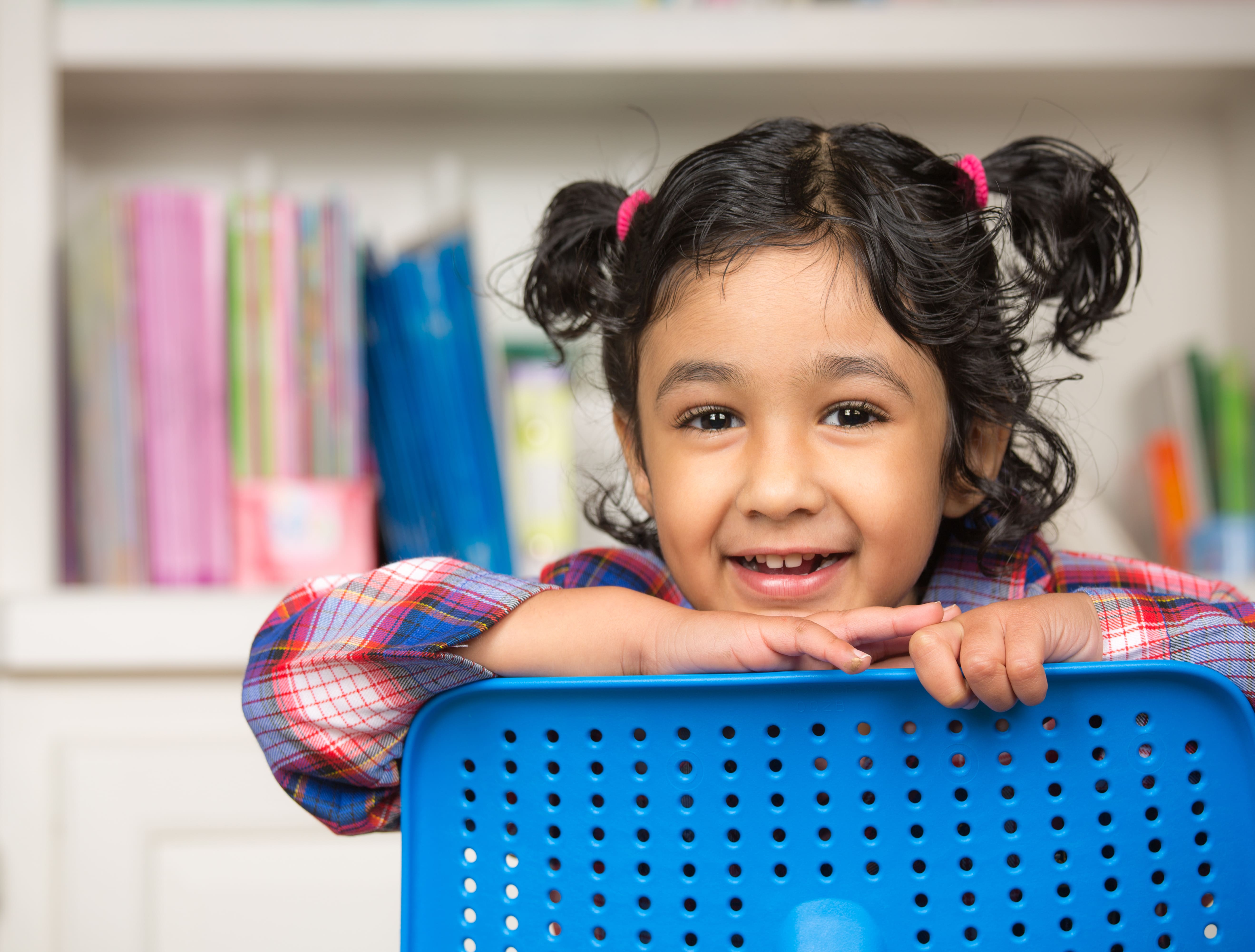 Kid smiling in school outfit