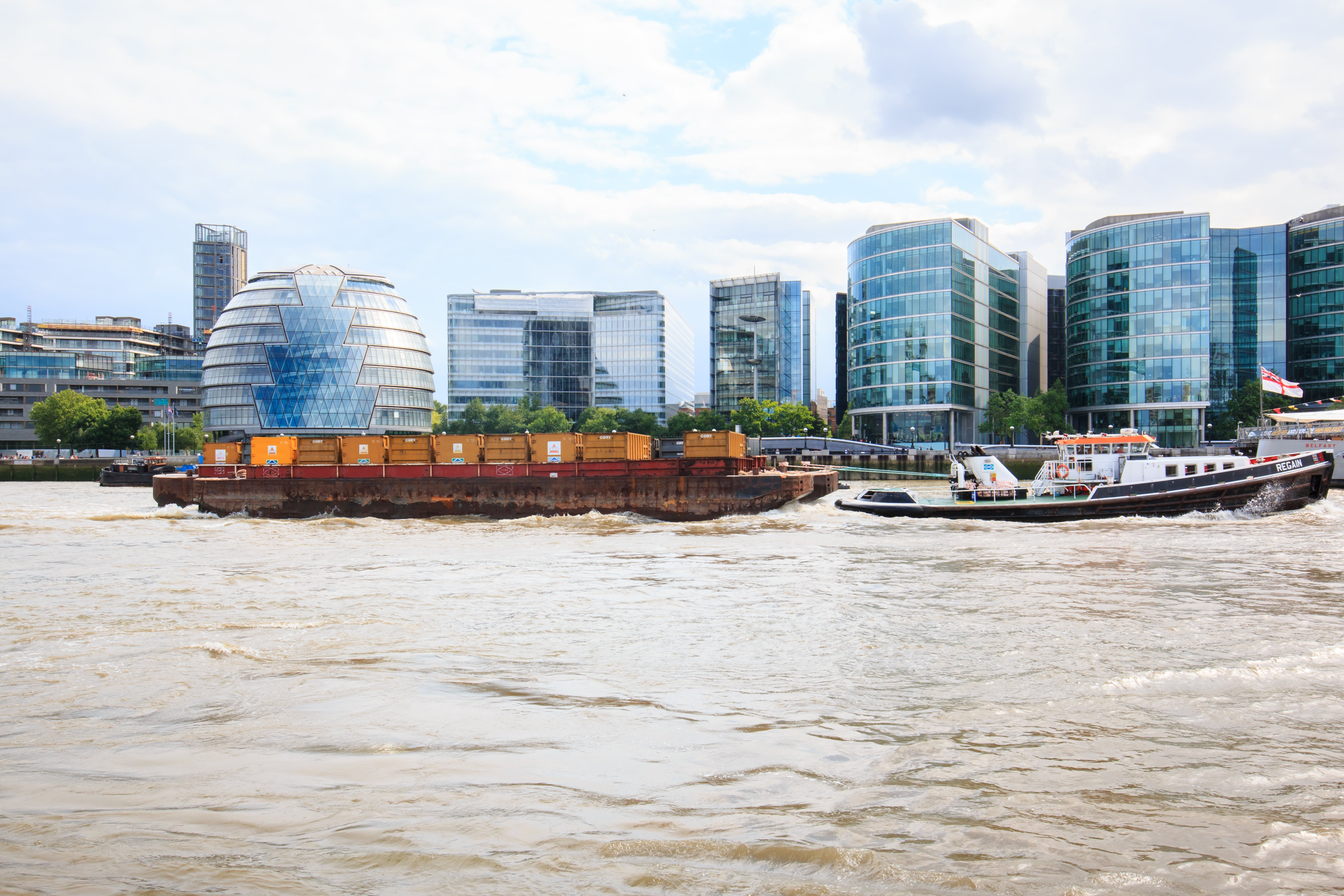 Modern London buildings along a river, UK